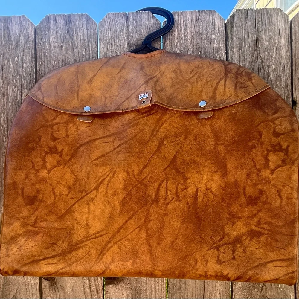 Vintage leather carry on for hanging clothes.